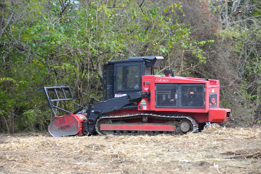 Tracked forestry mulcher working at the edge of overgrown brush